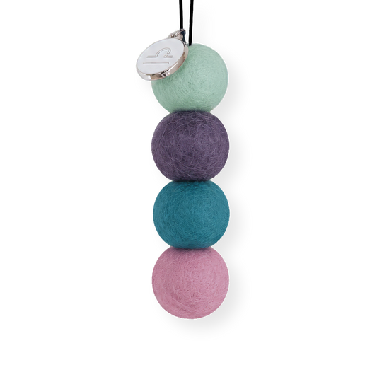 Four reusable wool felt air freshener balls in sage green, deep dusty purple, teal blue, and soft pastel pink for the Libra Zodiac Set.
