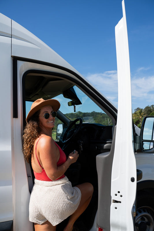 A girl and her van with Smelly Balls Car Air Freshener hanging from the rear view mirro