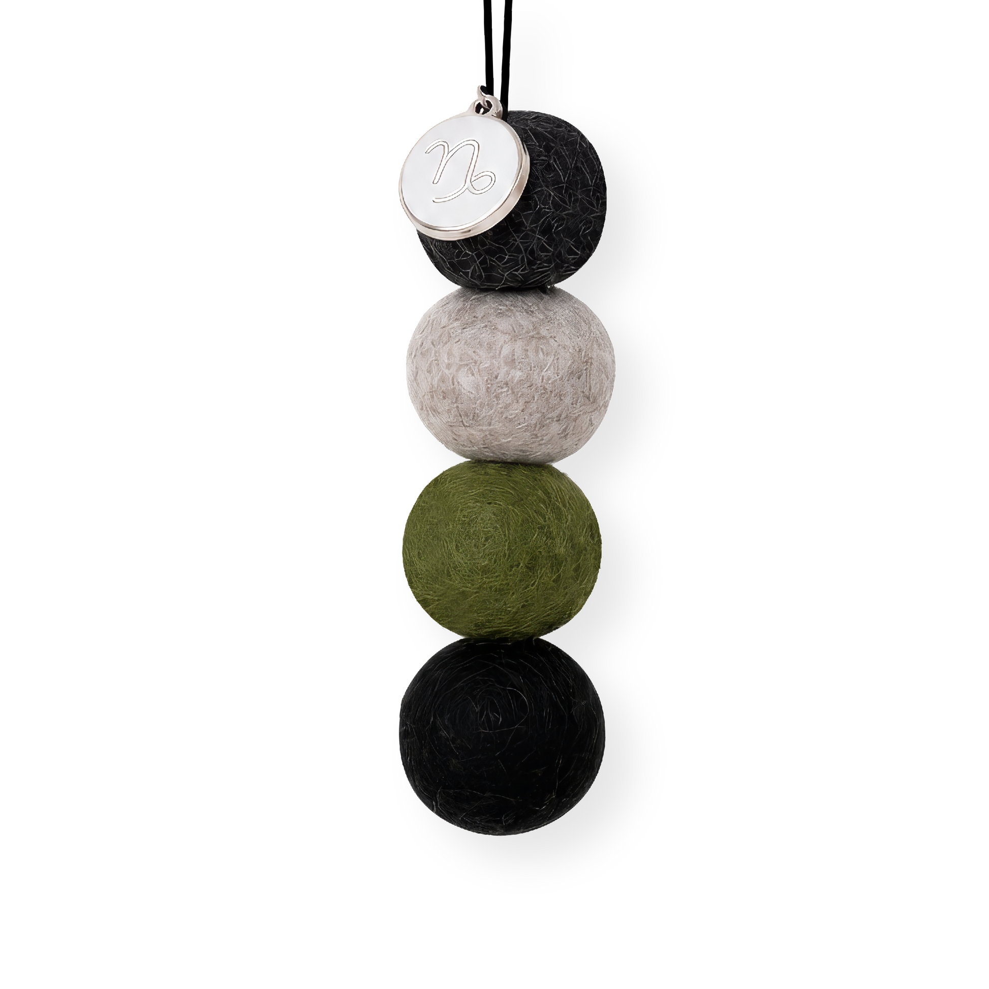 Four reusable wool felt air freshener balls in dark charcoal grey, cool stone grey, deep olive green, and classic black for the Capricorn Zodiac Set.