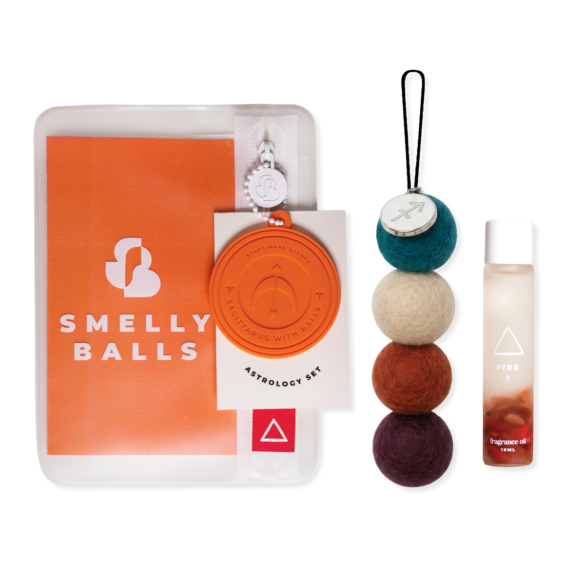 An astrology-themed 'Smelly Balls' kit by Smelly Balls, featuring an orange booklet, a wax seal keychain, a four-colored Reusable Air Freshener, and a 10ml fragrance oil bottle infused with crustals. 