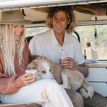 Couple in a van with a dog and Smelly Balls air freshener.